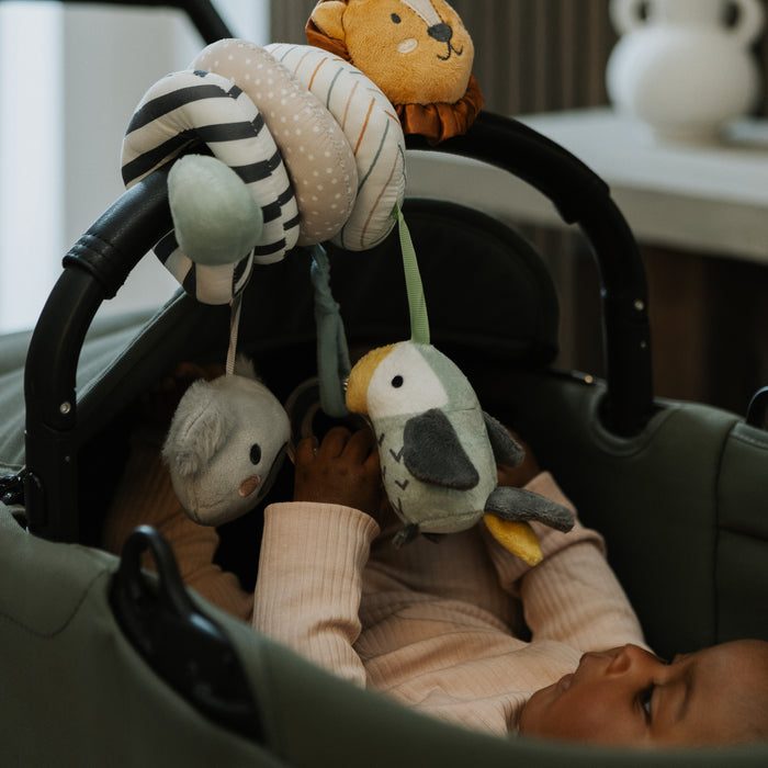 A baby in a stroller reaches for the Animal Adventures Bundle’s plush lion, bird, and koala mobile—sparking animal-inspired play. This charming set is a perfect addition to any toy bundle or as a thoughtful baby shower gift.