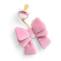 Pink velvet bow with a pacifier on a white background