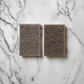 Natural fibre scouring pads on white marble kitchen counter – compostable cleaning pads in Calgary from Cuprea