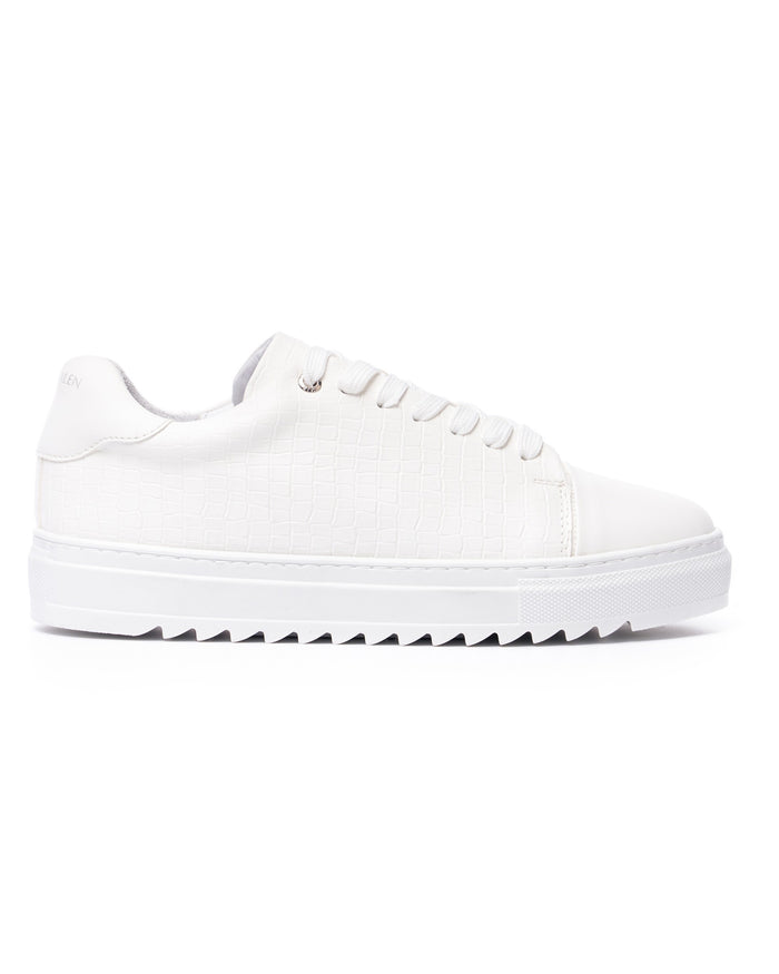 Martin Valen Dino low-top white sneaker, side view showing croc-texture upper and serrated sole