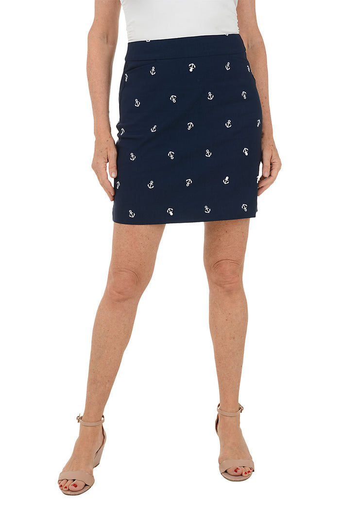 Navy blue skirt with white anchor pattern worn by a person on a white background.