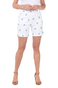 White shorts with blue turtle patterns worn by a person on a white background