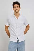 Flint Collared Button Shirt with Short Sleeves and a Chest Pocket in White Colorway. Front View Shown on Model.