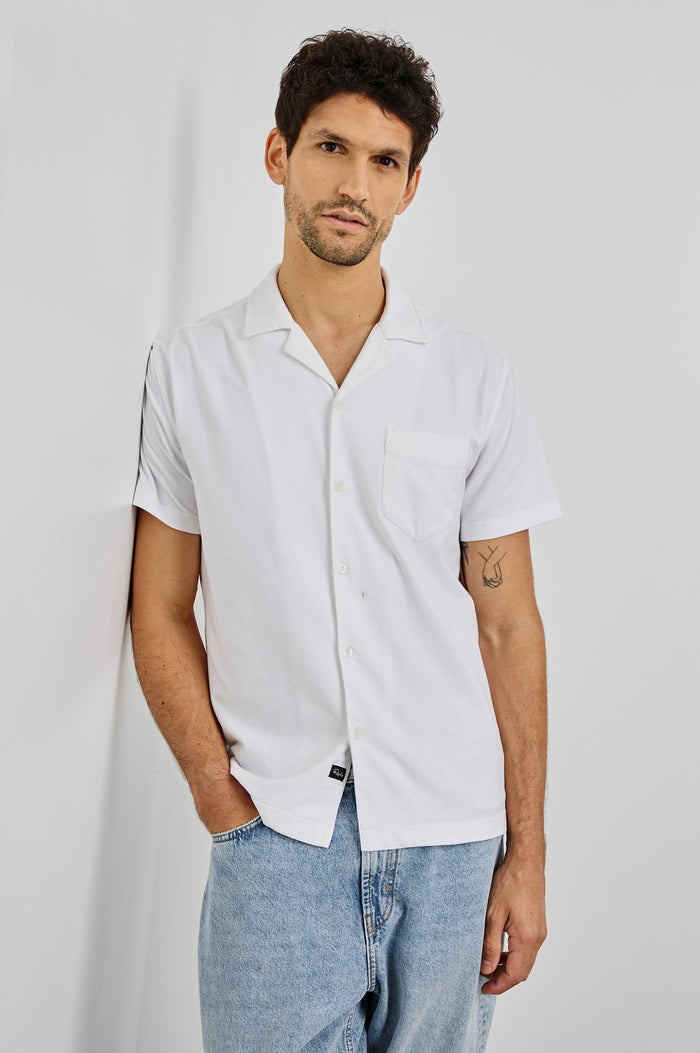 Flint Collared Button Shirt with Short Sleeves and a Chest Pocket in White Colorway. Front View Shown on Model.