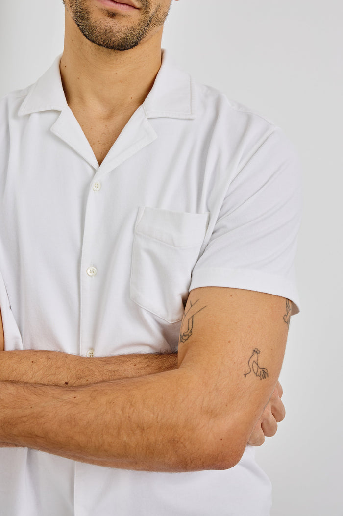 Flint Collared Button Shirt with Short Sleeves and a Chest Pocket in White Colorway. Front View Shown on Model.