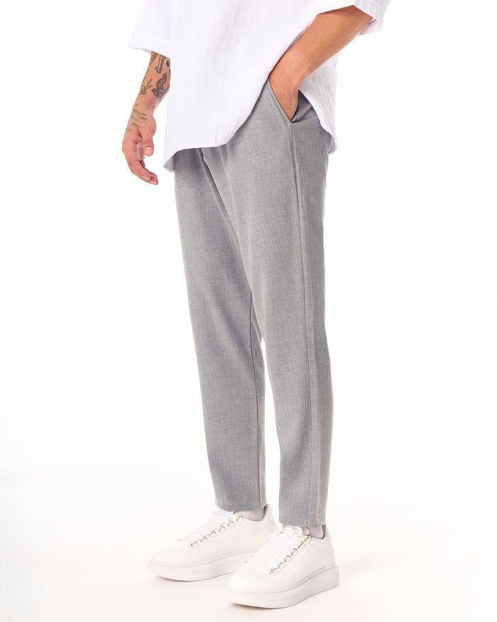 Martin Valen gray casual slim-fit trousers, full-length front view showing ankles and white sneakers