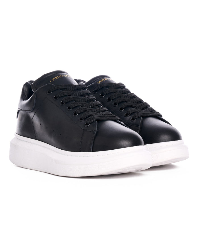 Martin Valen Hype Sole — pair of black sneakers seen front-on from a slight top angle, visible white soles