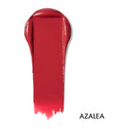 Swatch of lip & cheek cream in the shade 'Azalea'. Deep pinkish red.