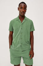Maverick Short Sleeve Shirt in French Terry With Jacquard Pattern, Notched Collar, Front Buttons, and Classic Fit in Green Bay Grid Colorway - Upper Body Front View Featured on Model