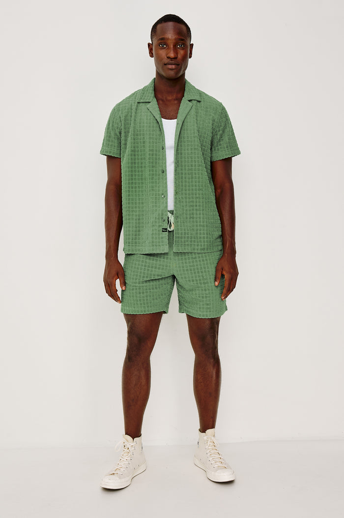 Maverick Short Sleeve Shirt in French Terry With Jacquard Pattern, Notched Collar, Front Buttons, and Classic Fit in Green Bay Grid Colorway - Full Body Front View Featured on Model