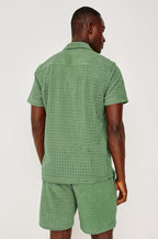 Maverick Short Sleeve Shirt in French Terry With Jacquard Pattern, Notched Collar, Front Buttons, and Classic Fit in Green Bay Grid Colorway - Upper Body Back View Featured on Model