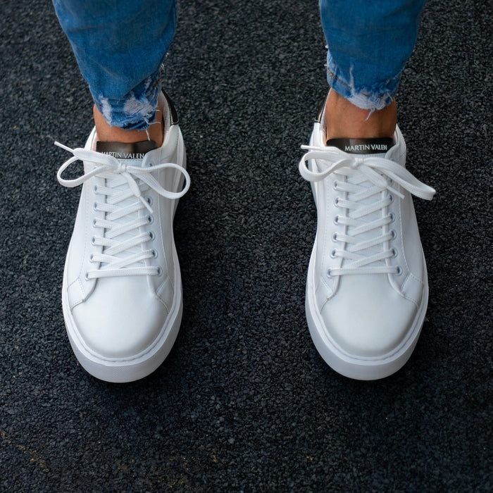 Martin Valen Iconic men's white-and-black casual sneakers, top view worn on feet showing laces and black branded tongues