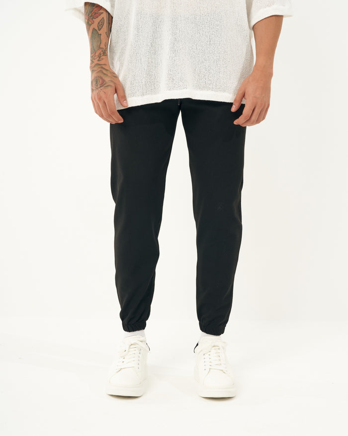 Martin Valen men's black jogger, front mid-shot showing elastic waist and cuffed ankles