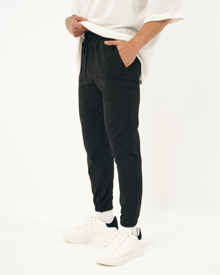 Martin Valen men's black jogger, close side view showing pocket and drawstring at the elastic waist