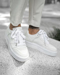 Martin Valen men's white high sneakers, top-front view worn on concrete showing thick platform sole and laced upper