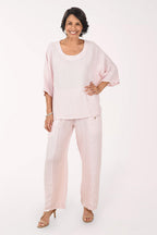 Woman wearing a light pink outfit on a white background