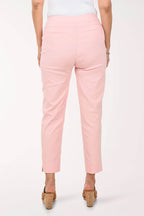 Person wearing light pink pants on a white background - back shot