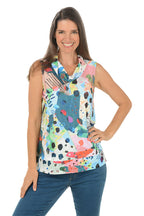Woman wearing a colorful sleeveless top with abstract patterns on a white background. Second front shot.