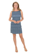 Woman wearing a blue and white patterned dress on a white background.