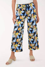 Floral-patterned pants worn by a person on a white background