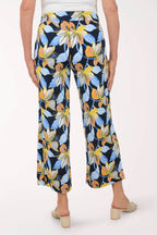 Floral-patterned pants worn by a person on a white background