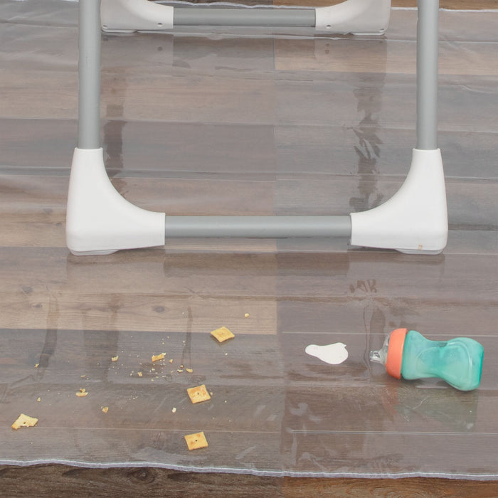The Nuby US No-Mess Mealtime Mat protects wooden floors under high chairs by catching crumbs, spilled food, and sippy cups—making post-meal cleanup quick and easy.