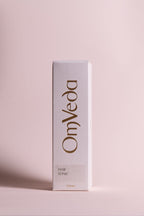 OmVeda hair tonic box, white packaging with brown logo text