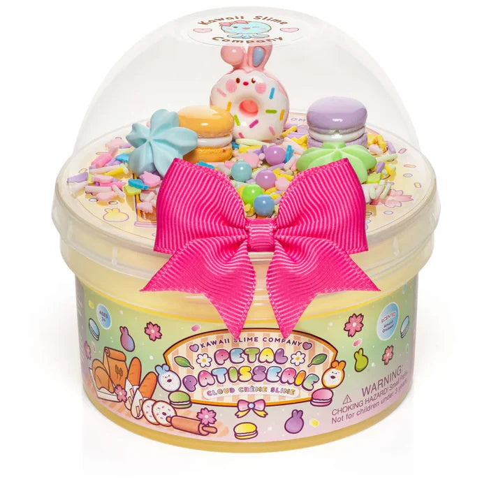 Toy set in a decorative container with a pink bow on a white background
