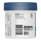 Back view of a white plastic supplement jar with a blue lid, showing the back label with text, a barcode, and recycling symbols.
