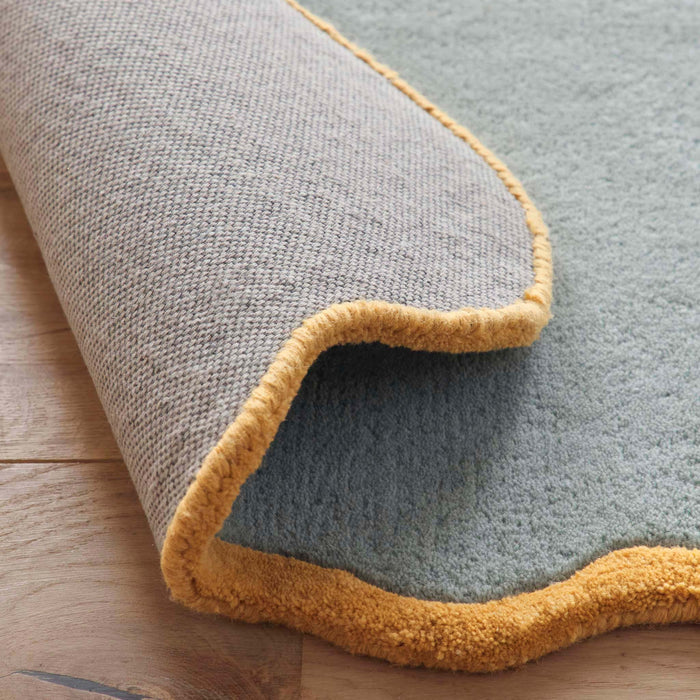 Scalloped Elise Duck Egg Ochre Rug - a 100% wool blue rug featuring a scalloped yellow border.