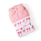 Pink baby bootie with floral and bow pattern on a white background