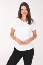 Woman wearing a white t-shirt and black pants on a white background