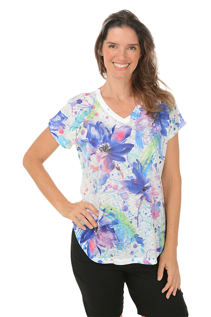 A woman wearing a multi colored floral short sleeve top. Second front shot.