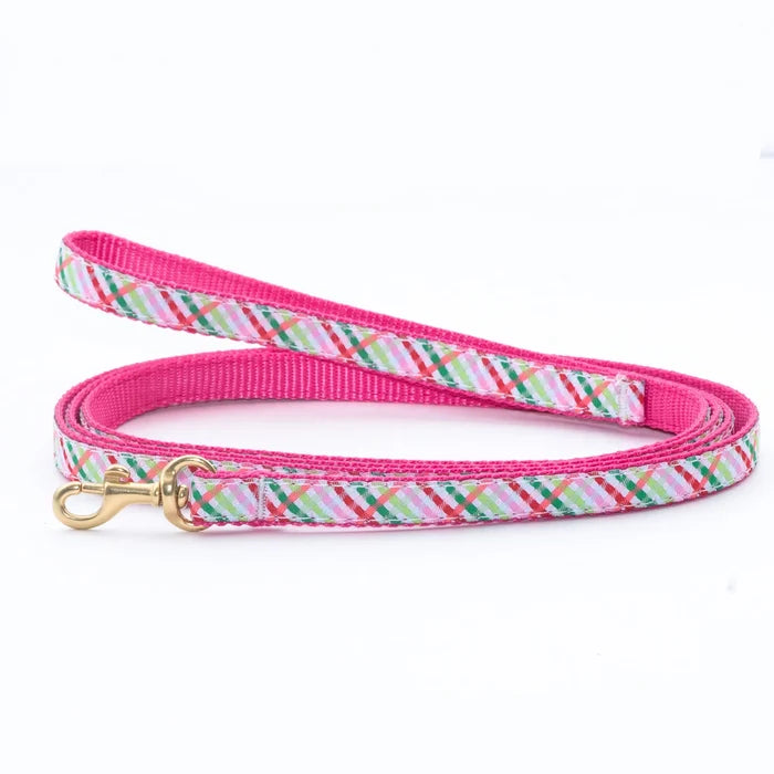 Dog leash with pink and multicolor plaid pattern on a white background