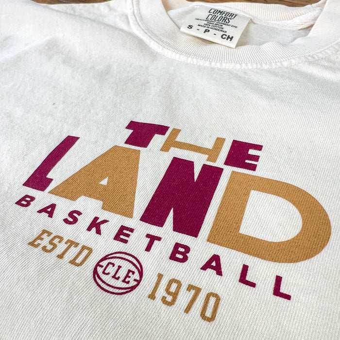 White sweatshirt with 'The Land Basketball' text and logo on a white background